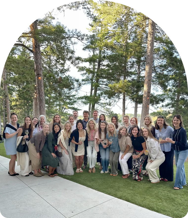 Branch Basics employees posing for a group-photo outdoors with trees in the background