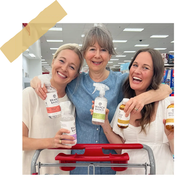 Allison, Marilee, and Kelly in Target holding cleaning products branded Branch Basics; image contained within a frame to look like a polaroid.